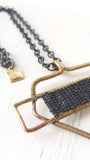 BLACK AND BRASS PROTECTIVE SHIELD NECKLACE